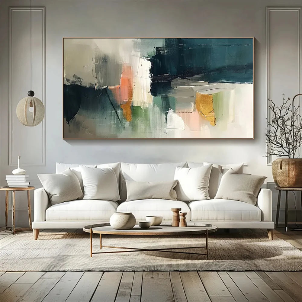 Horizontal colorful abstract canvas with muted blocks above a white sofa by Wonder Artwork